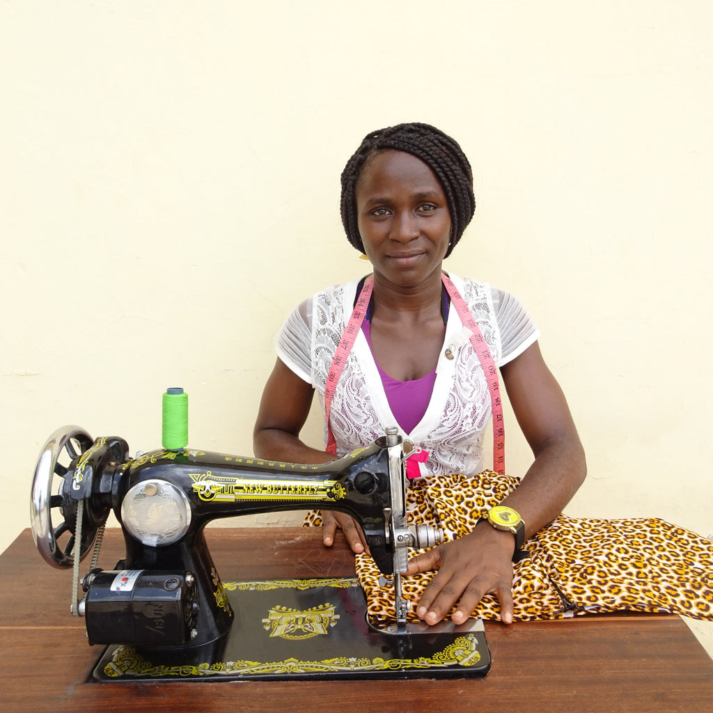 Seamstress Cinderella behind her sewing machine
