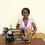 Load image into Gallery viewer, Seamstress Cinderella behind her sewing machine
